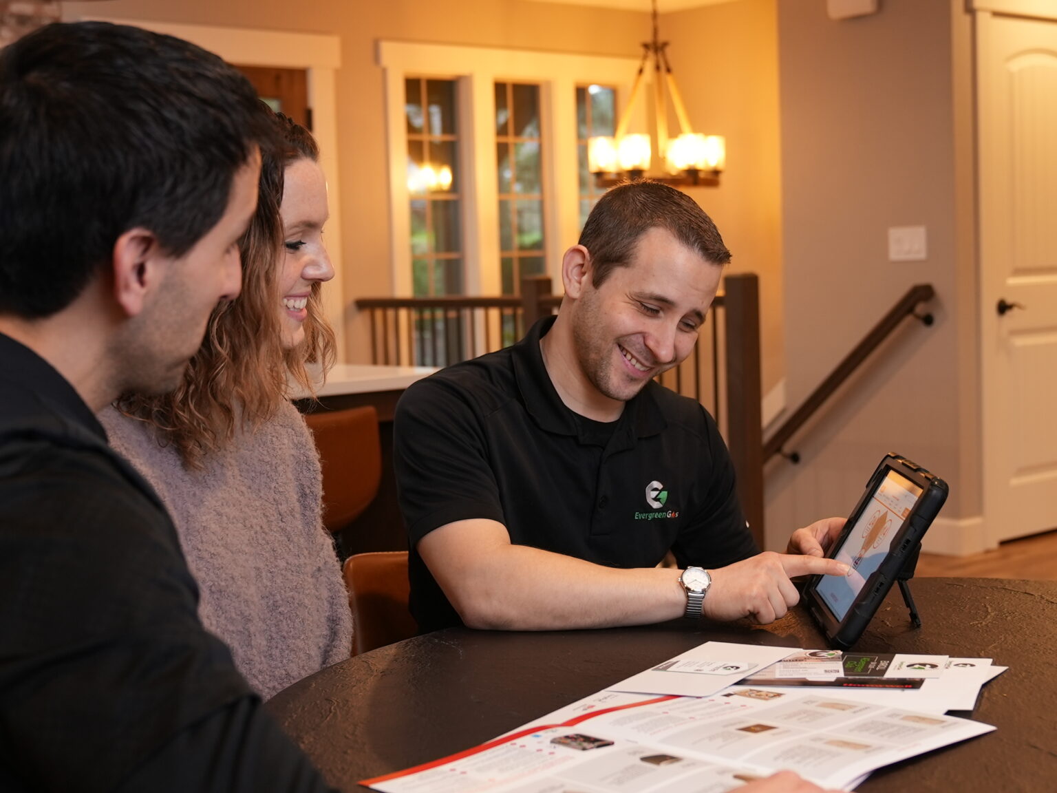 Evergreen Gas service technician reviewing plans with homeowners