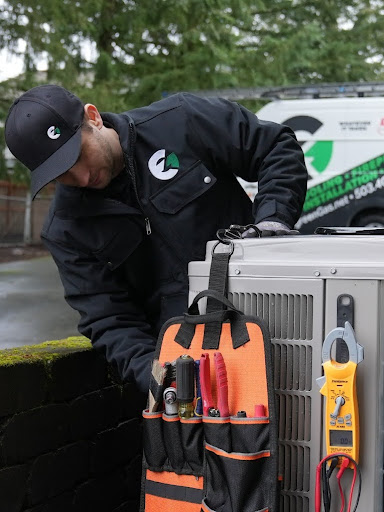 An Evergreen technician working on an ac system